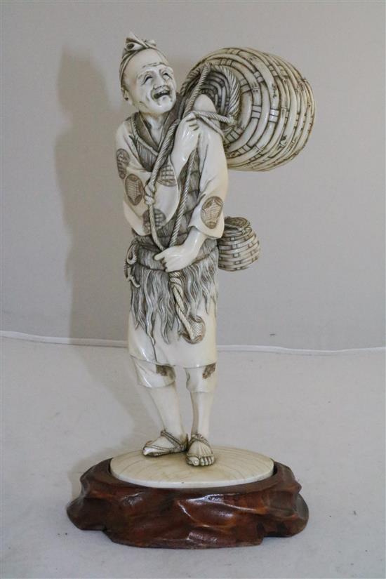 A large Japanese ivory figure of a fisherman, Meiji period, 25.5cm, wood stand